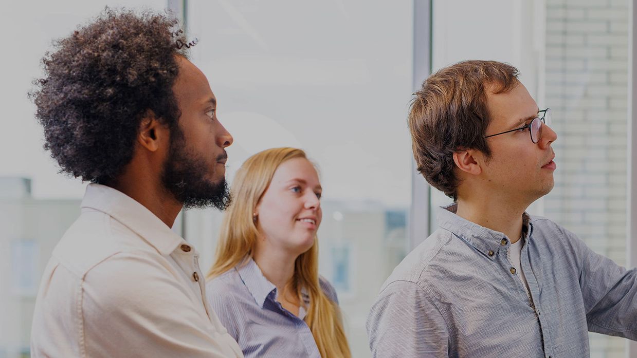 engineers discussing at whiteboard
