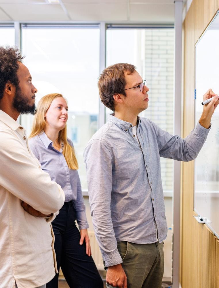 engineers brainstorming at whiteboard