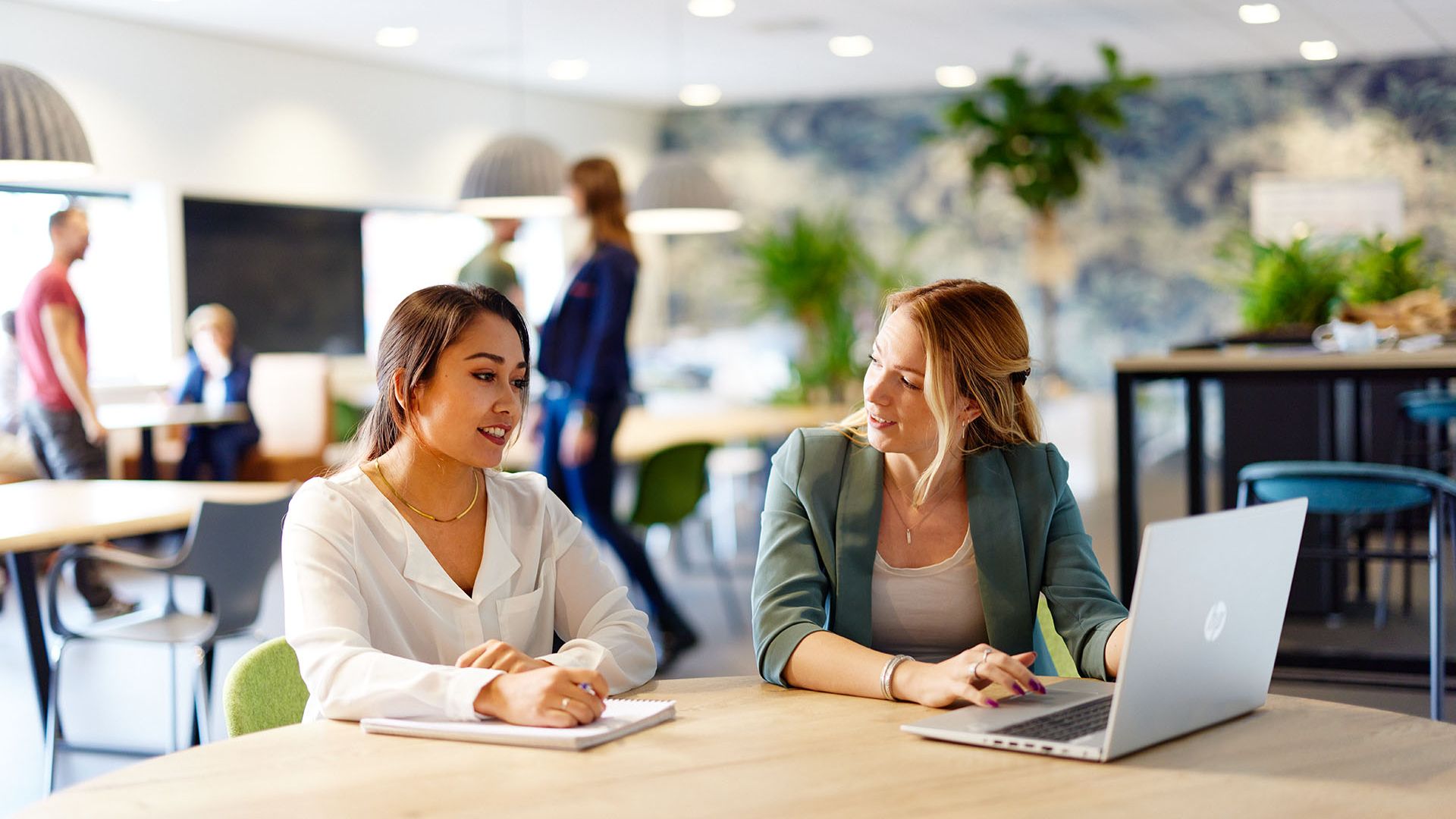 two people discussing behind desk